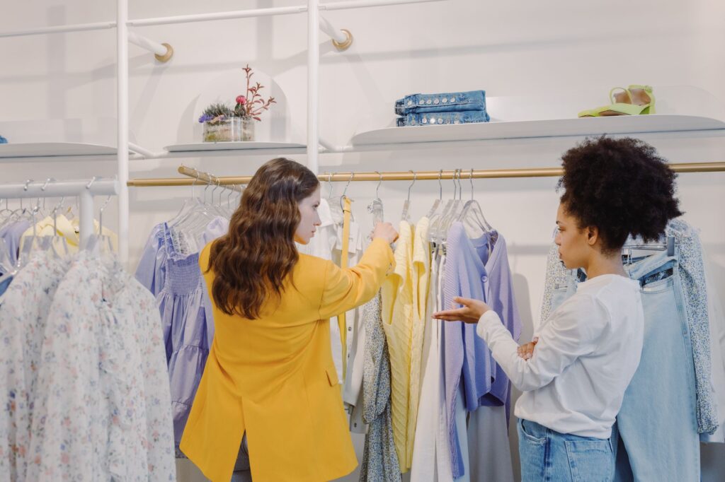 Two women browsing clothing in a stylish boutique, exploring various fashion options, women's clothing boutique palmyra